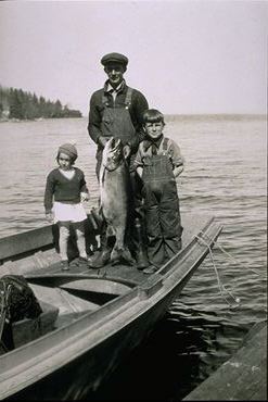 fisherman with children in skiff